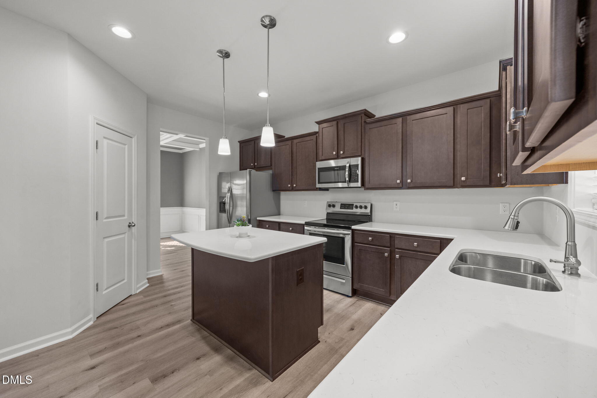 161 Starlight Road Lillington, NC 27546 - Photo 11 of 45 a kitchen with kitchen island stainless steel appliances a sink a stove a refrigerator and cabinets
