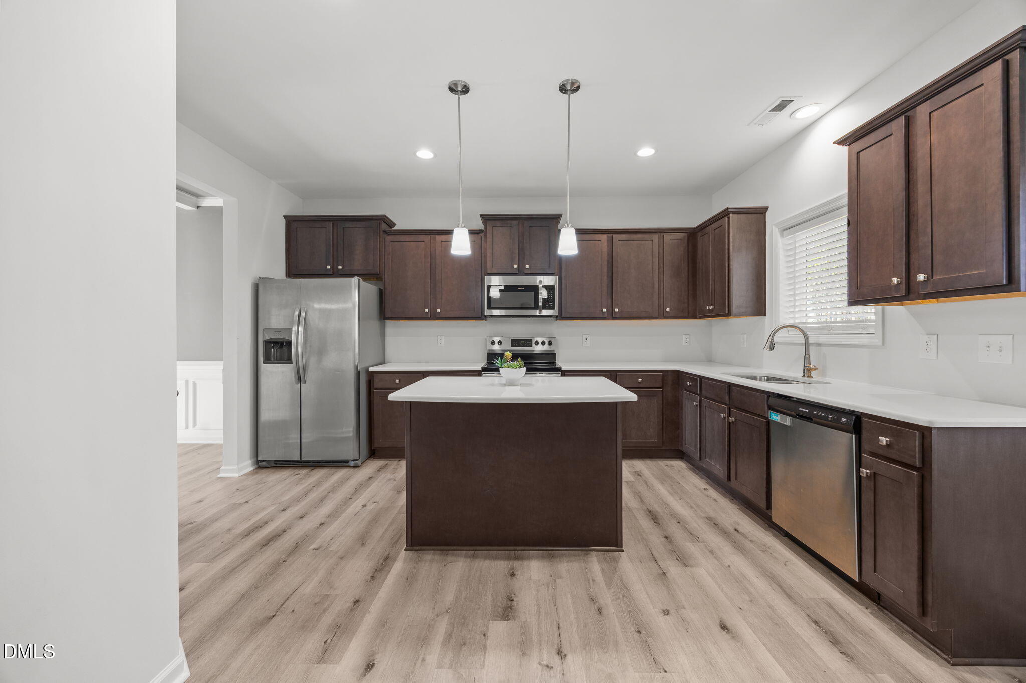 161 Starlight Road Lillington, NC 27546 - Photo 12 of 45 a kitchen with refrigerator and cabinets