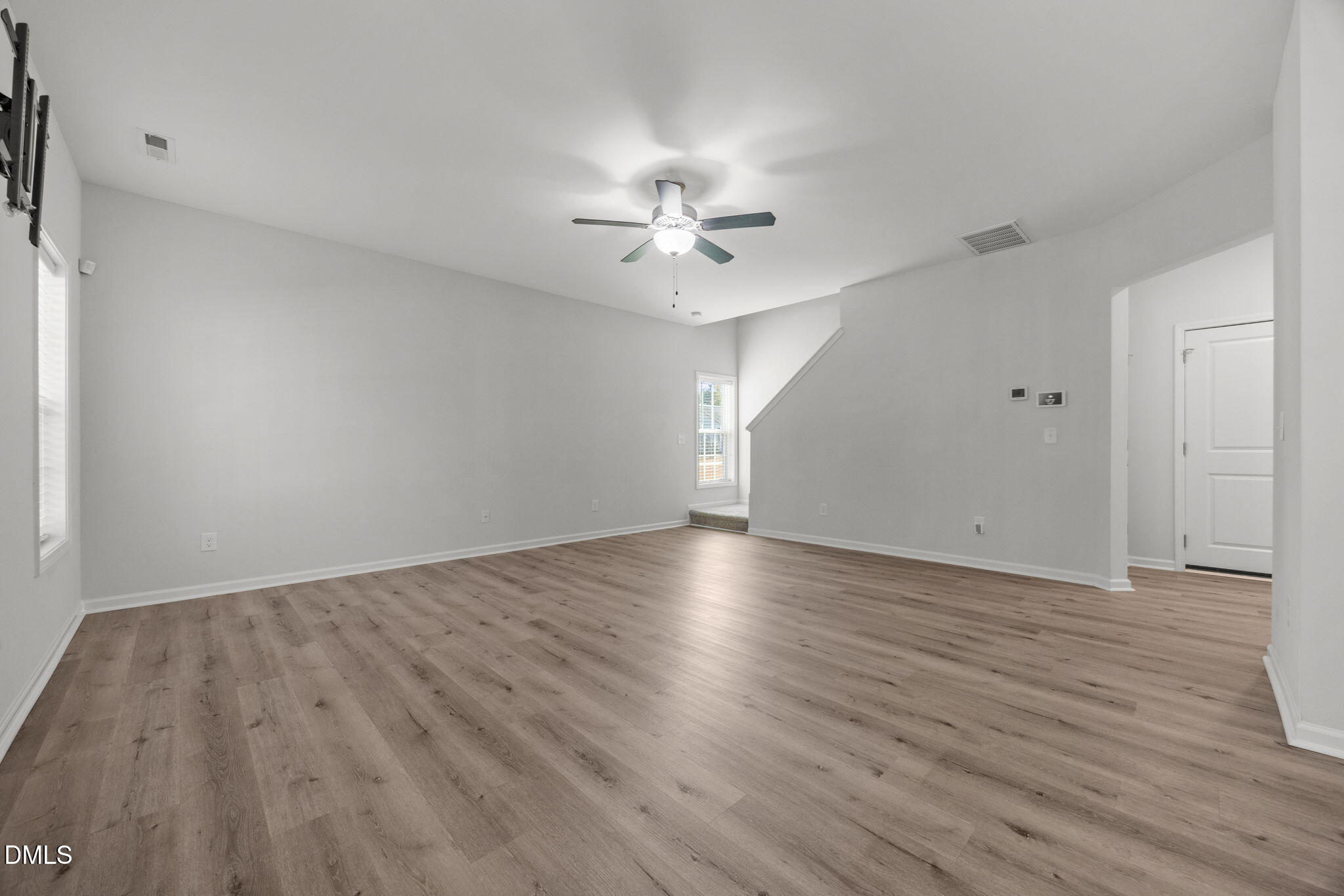 161 Starlight Road Lillington, NC 27546 - Photo 16 of 45 an empty room with wooden floor and a ceiling fan