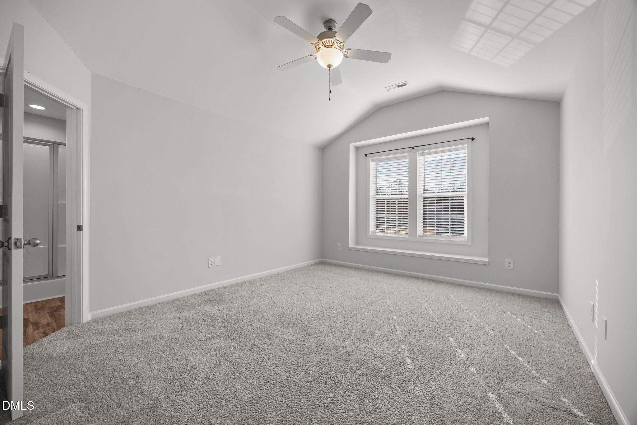 161 Starlight Road Lillington, NC 27546 - Photo 20 of 45 an empty room with chandelier fan and windows