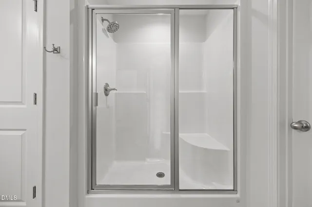 a bathroom with a glass shower door