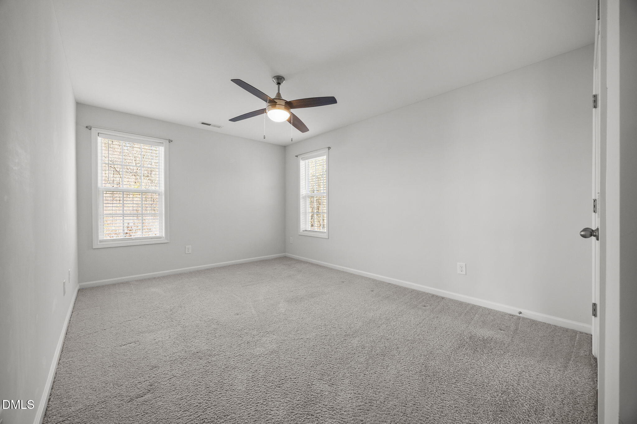 161 Starlight Road Lillington, NC 27546 - Photo 29 of 45 an empty room with windows and fan