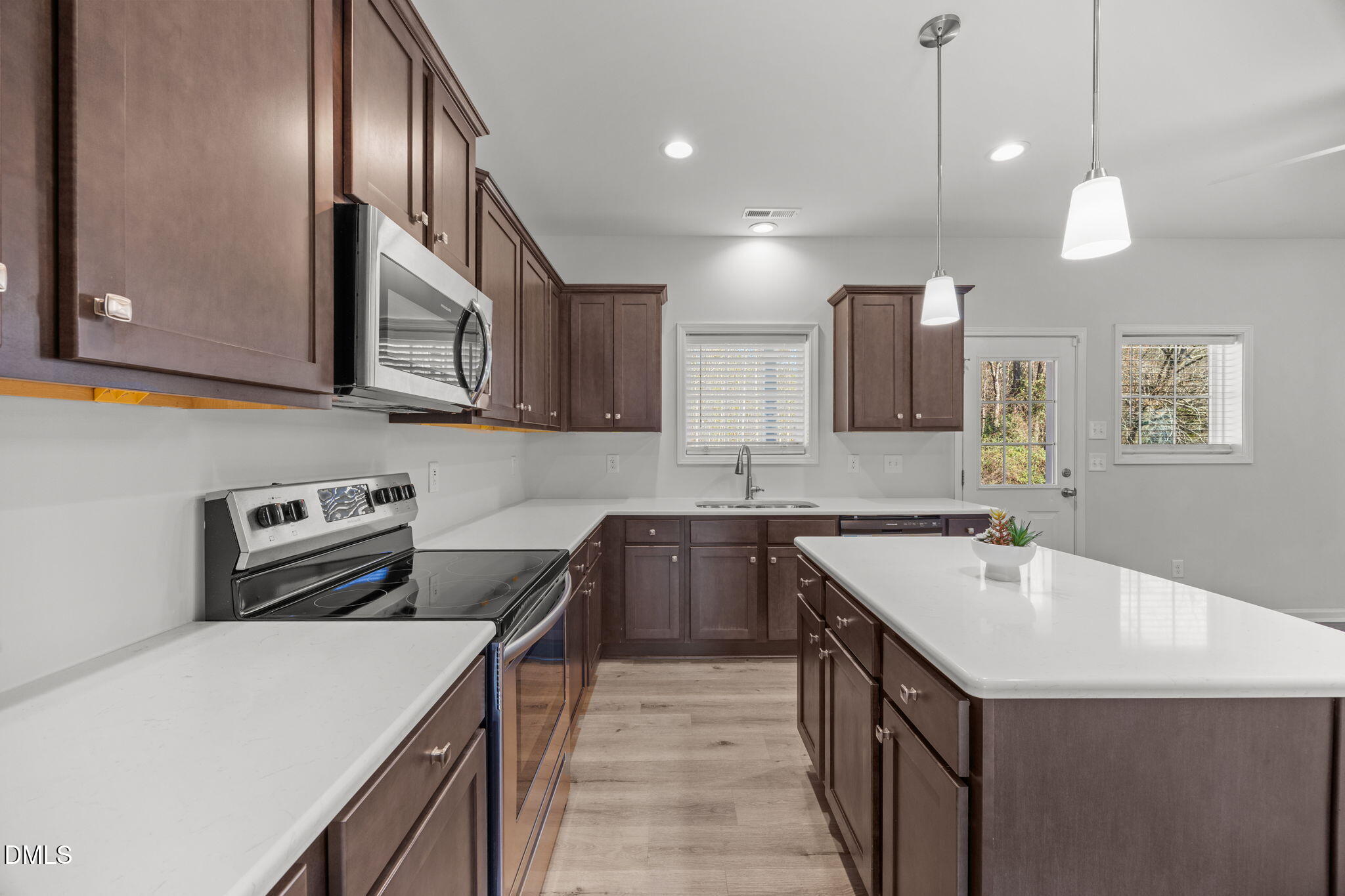 161 Starlight Road Lillington, NC 27546 - Photo 8 of 45 a kitchen that has a sink a stove and a microwave
