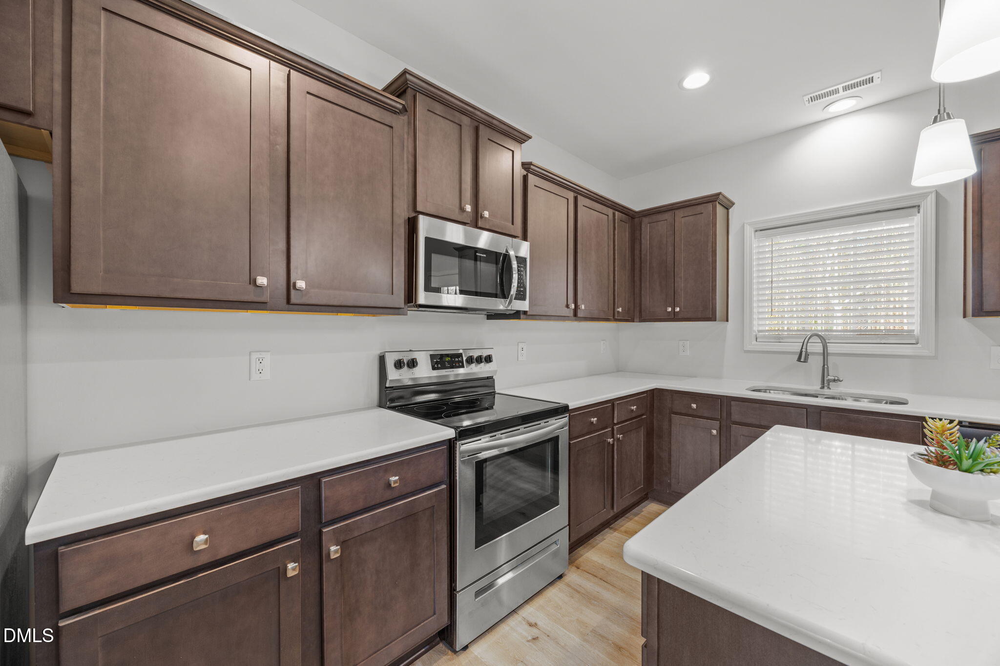 161 Starlight Road Lillington, NC 27546 - Photo 10 of 45 a kitchen with a sink a stove and cabinets