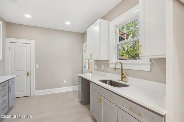 a kitchen that has a sink and a stove in it