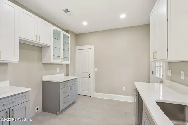 a kitchen with a sink and cabinets