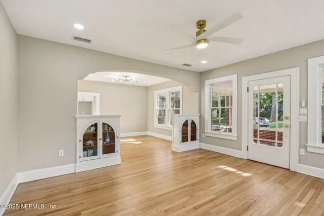 a view of a livingroom with a ceiling fan and window