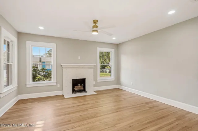 wooden floor in an empty room with a window