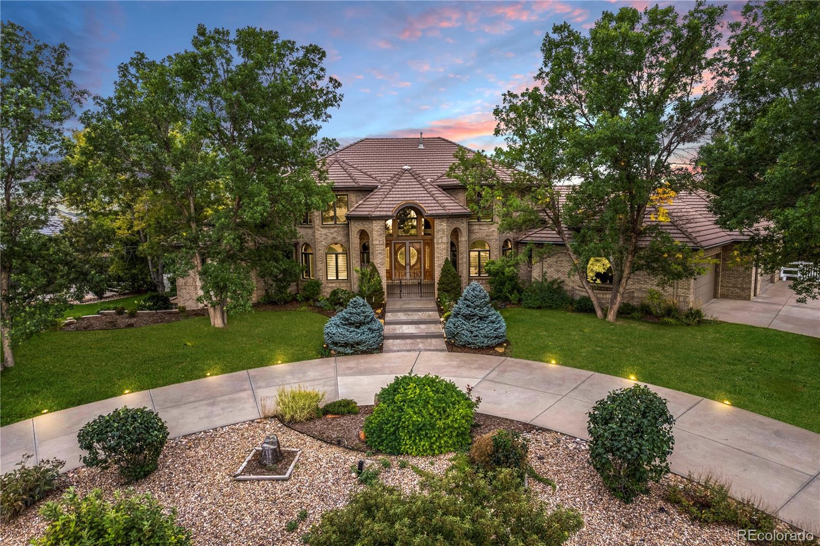 14046 Lexington Circle Westminster, CO 80023 - Photo 1 of 40 a front view of a house with garden and tree s