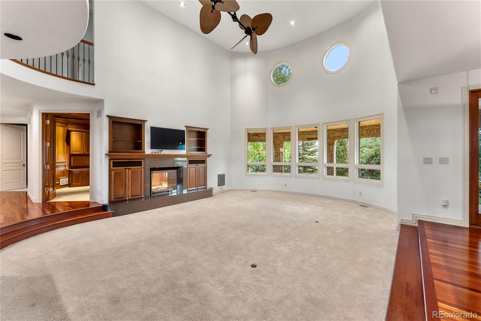 14046 Lexington Circle Westminster, CO 80023 - Photo 14 of 40 a view of an empty room with a fireplace and a window