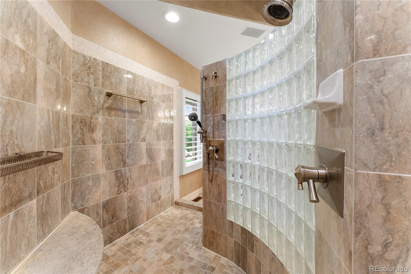 14046 Lexington Circle Westminster, CO 80023 - Photo 21 of 40 a bathroom with a shower