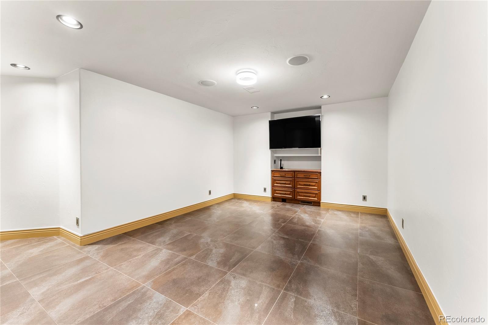 14046 Lexington Circle Westminster, CO 80023 - Photo 22 of 40 a view of an empty room with wooden floor
