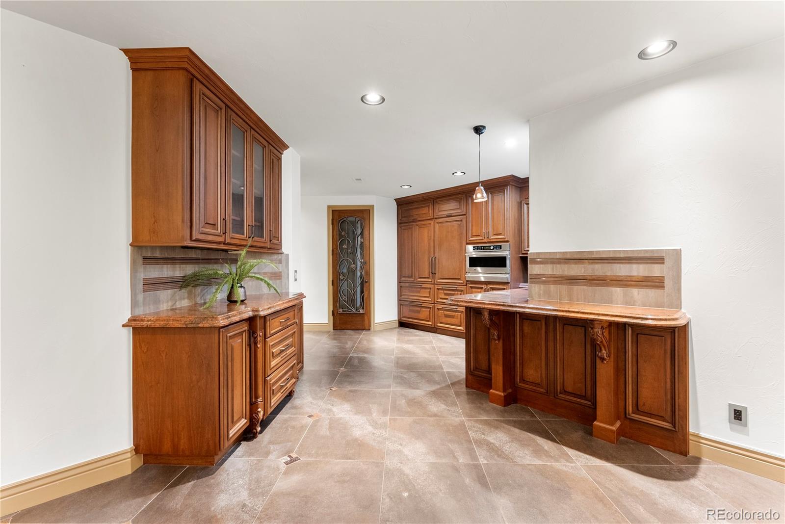 14046 Lexington Circle Westminster, CO 80023 - Photo 24 of 40 a kitchen with stainless steel appliances granite countertop a stove and cabinets