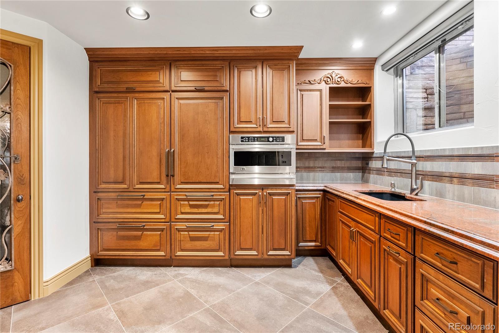 14046 Lexington Circle Westminster, CO 80023 - Photo 25 of 40 a kitchen with stainless steel appliances granite countertop a refrigerator and a sink