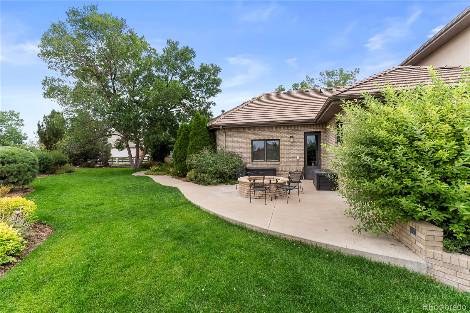 14046 Lexington Circle Westminster, CO 80023 - Photo 28 of 40 a view of a chair and table in backyard of the house