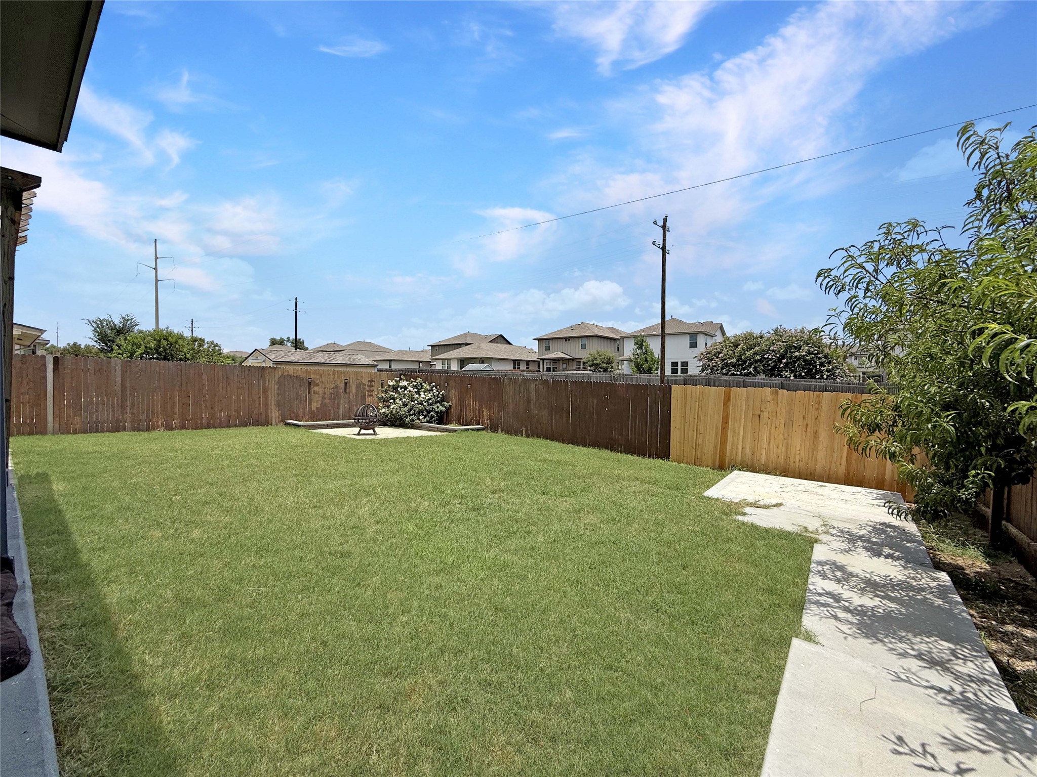 429 Rusk Bluff Avenue Leander, TX 78641 - Photo 21 of 24 A well-maintained lawn offers ample space for outdoor enjoyment within a privacy-fenced yard.