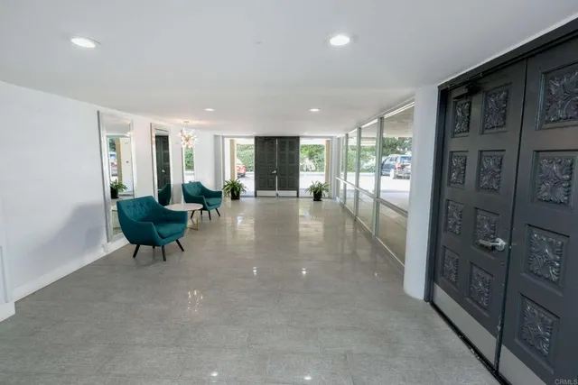 a lobby with furniture and large windows