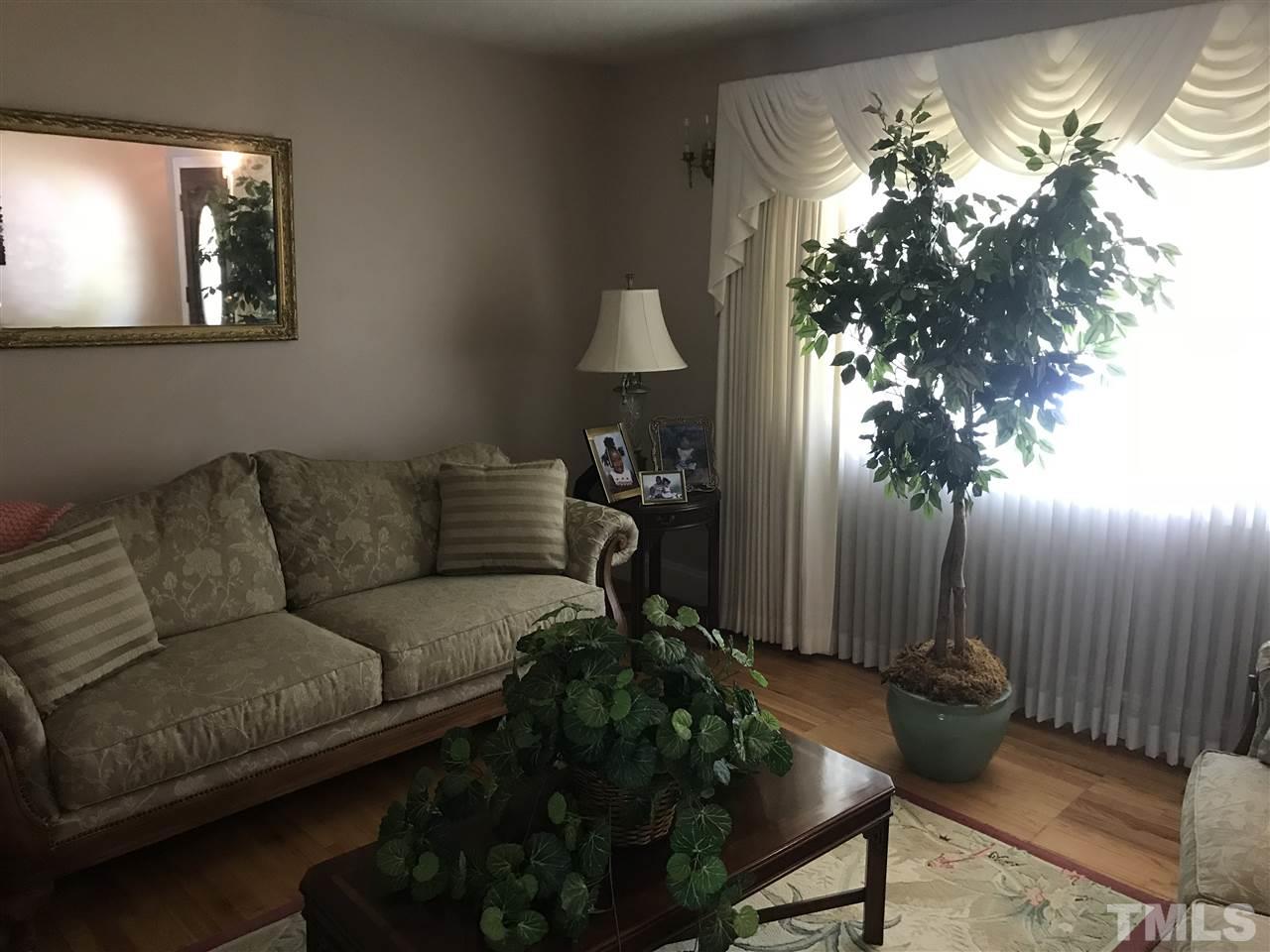 1909 Tee Dee Street Raleigh, NC 27610 - Photo 1 of 17 a living room with furniture and a chandelier