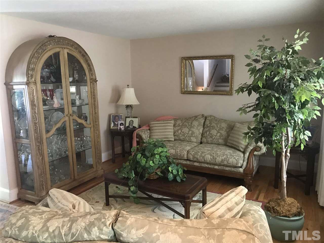 1909 Tee Dee Street Raleigh, NC 27610 - Photo 3 of 17 a living room with furniture and a potted plant