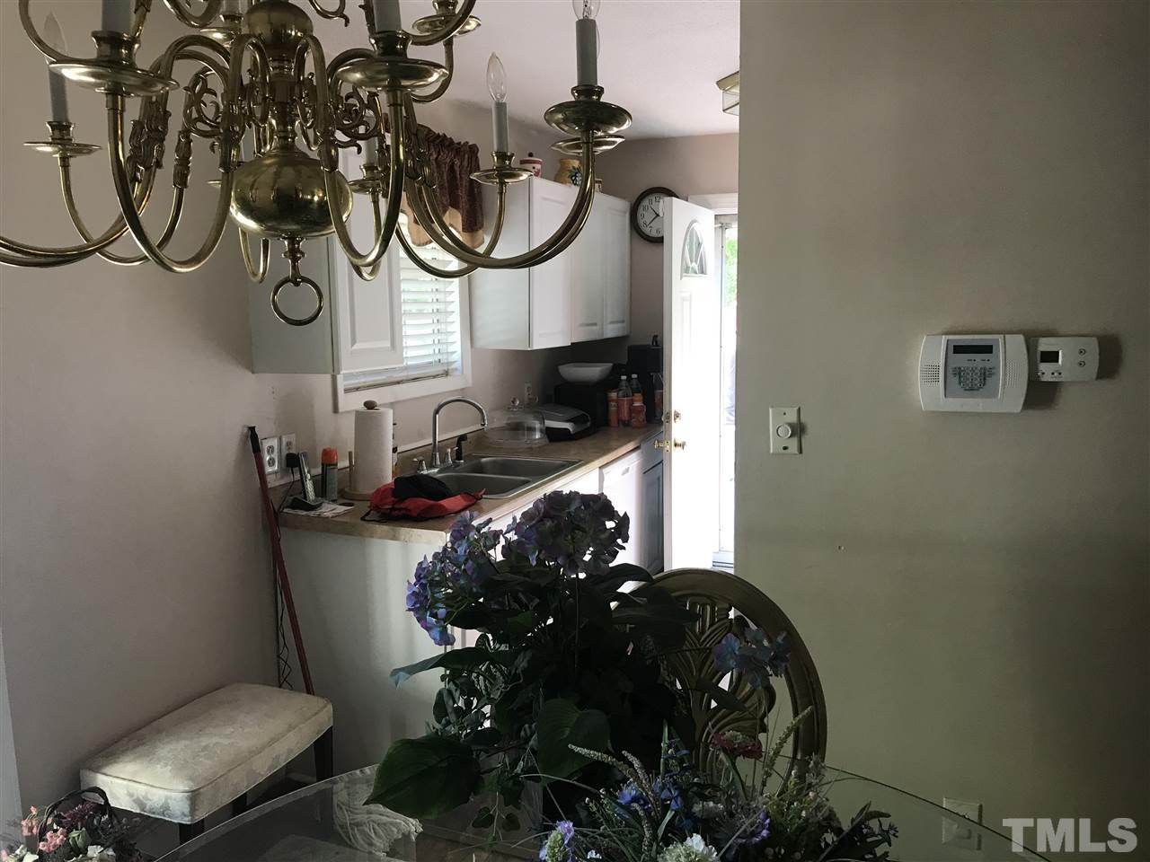 1909 Tee Dee Street Raleigh, NC 27610 - Photo 5 of 17 a bathroom with a toilet mirror and sink