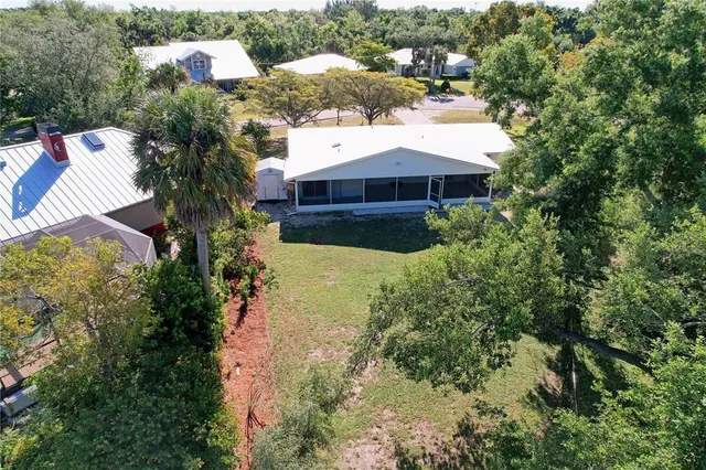 an aerial view of a house with a yard and garden
