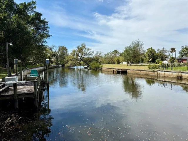 a view of a lake with boats and trees in the background