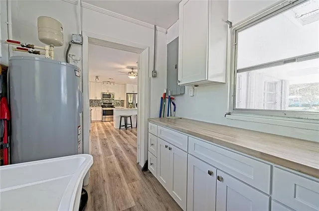 a kitchen with white cabinets sink and white appliances