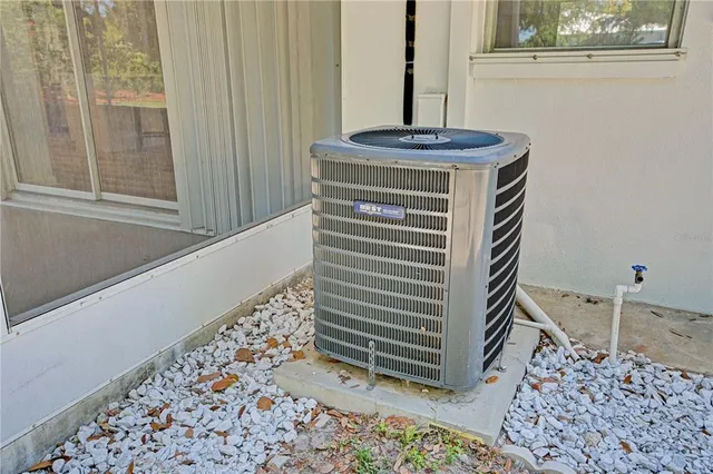 a front view of a house with a garden and trees