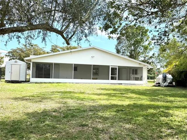 an aerial view of a house with large trees