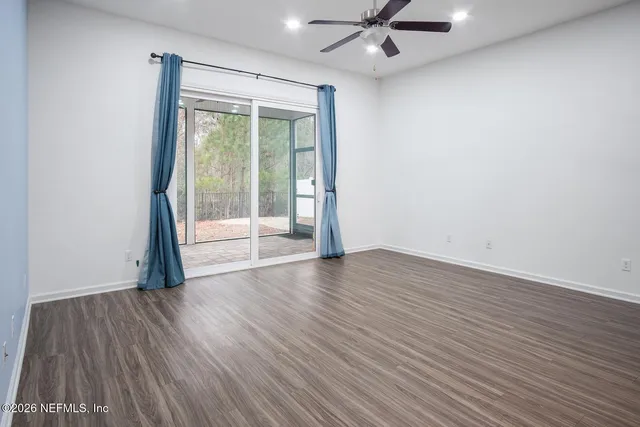 wooden floor in an empty room with a window