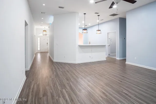 a view of a kitchen and wooden floor