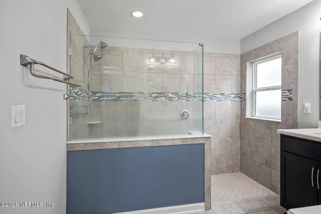 a bathroom with a shower and a sink