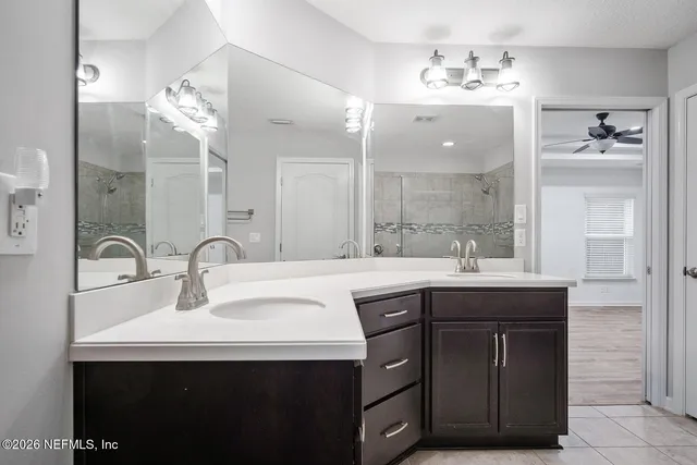 a bathroom with a sink double vanity and a mirror