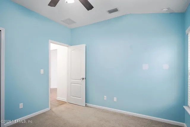 an empty room with closet area