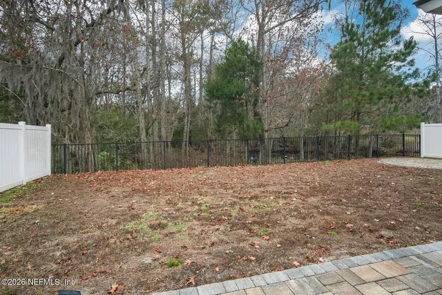 a backyard of a house with large trees