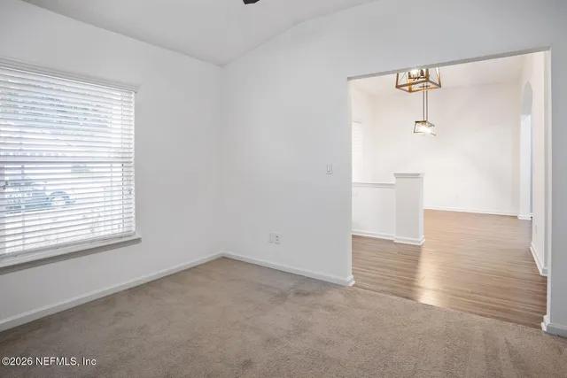 an empty room with a windows and closet