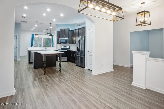 a view of living room with furniture and wooden floor