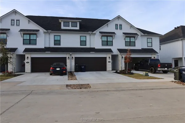 a view of a house with a outdoor space and a car parked