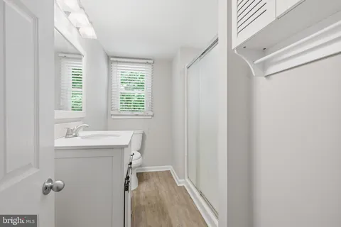a bathroom with a granite countertop sink mirror and a bathtub