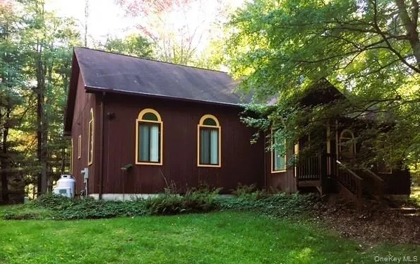 a front view of house with a garden