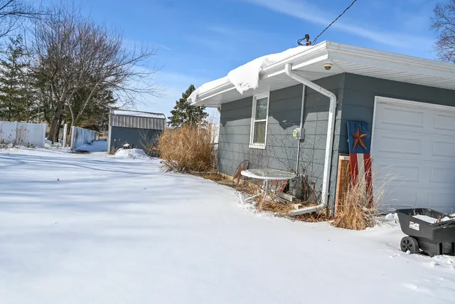 a view of a house with a snow in the yard