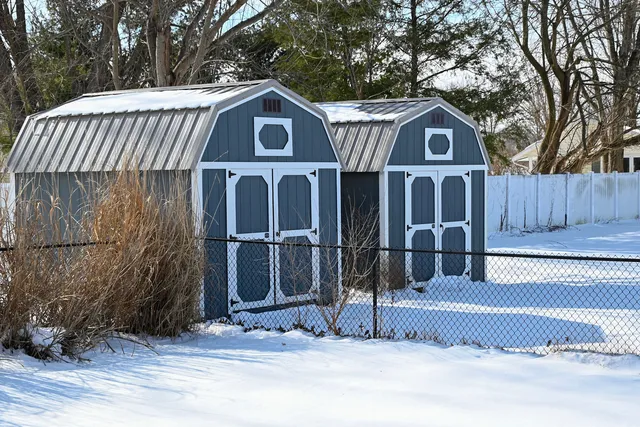 a view of a house with a yard and large tree