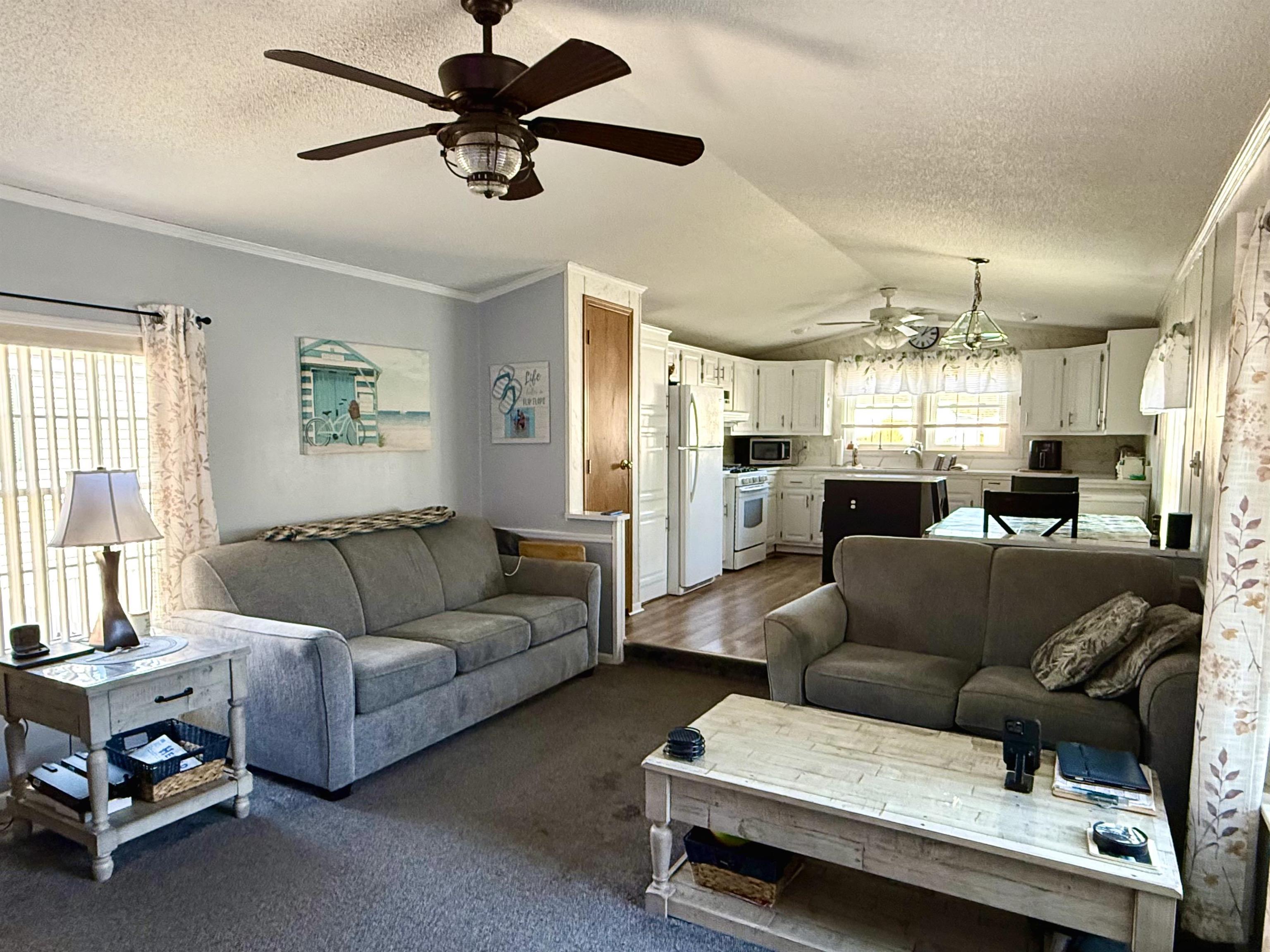 68 Priest Boulevard Rio Grande, NJ 08242 - Photo 5 of 28 a living room with furniture and a chandelier
