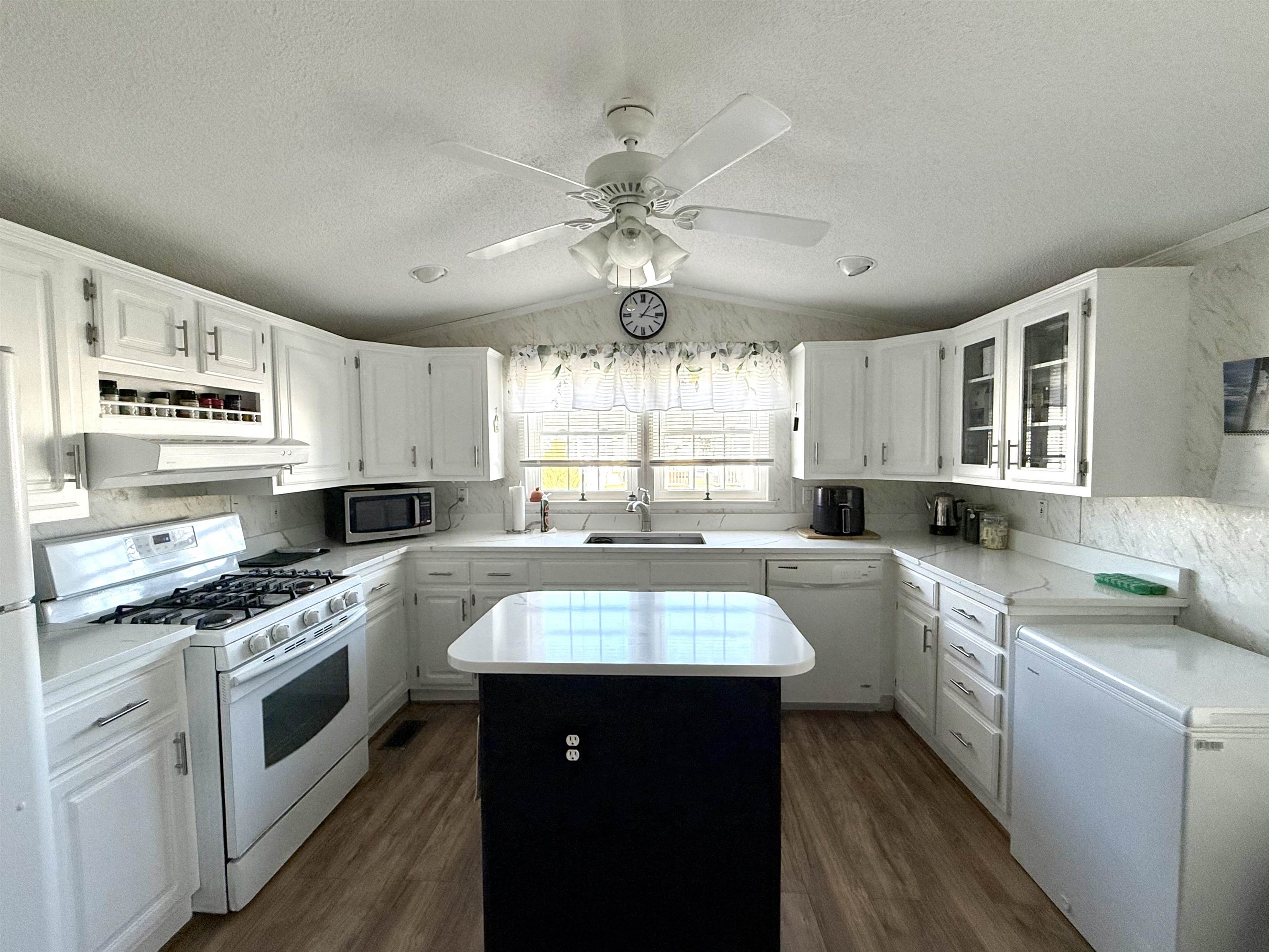 68 Priest Boulevard Rio Grande, NJ 08242 - Photo 9 of 28 a kitchen with stainless steel appliances granite countertop a sink a stove and cabinets