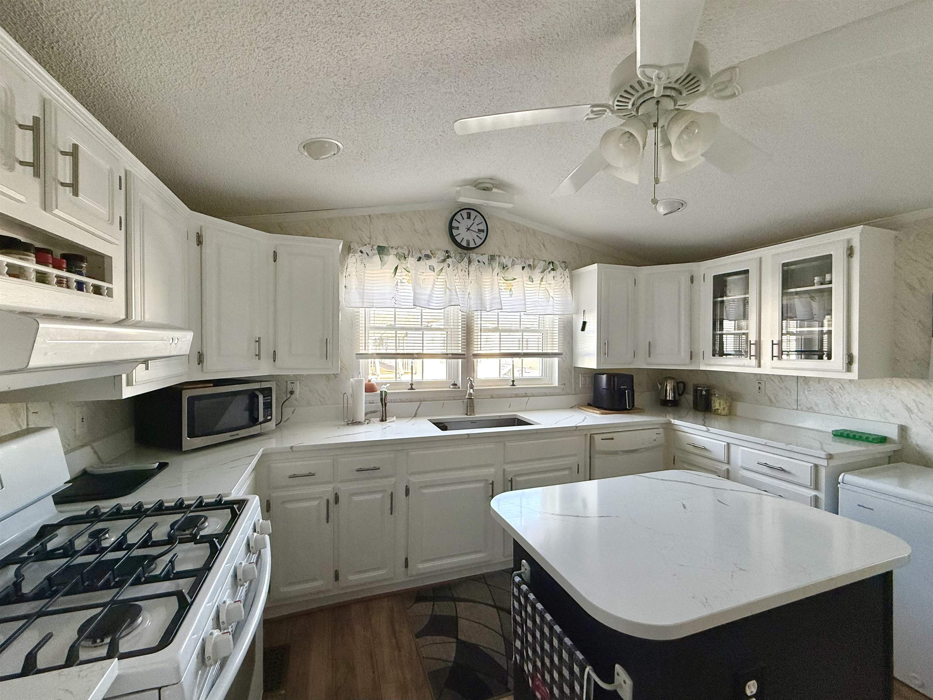 68 Priest Boulevard Rio Grande, NJ 08242 - Photo 10 of 28 a kitchen with stainless steel appliances a sink a stove a refrigerator cabinets and dining table