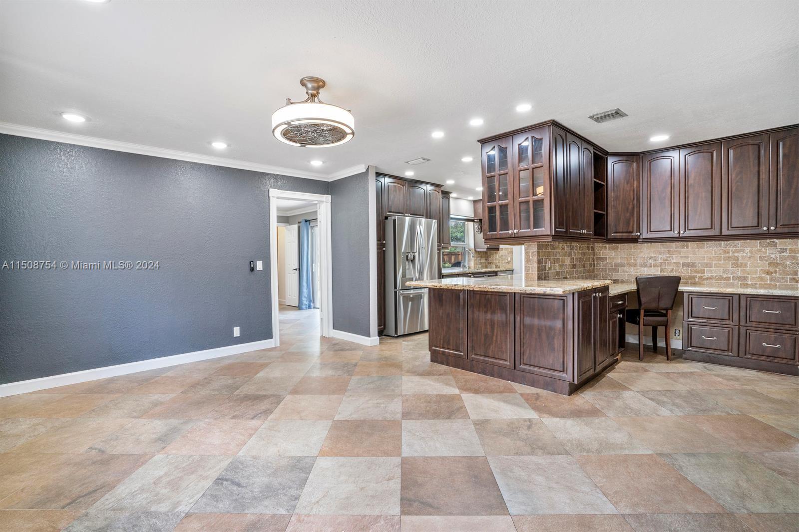 6900 Martin Road Margate, FL 33068 - Photo 7 of 11 a large kitchen with a large counter top stainless steel appliances and cabinets