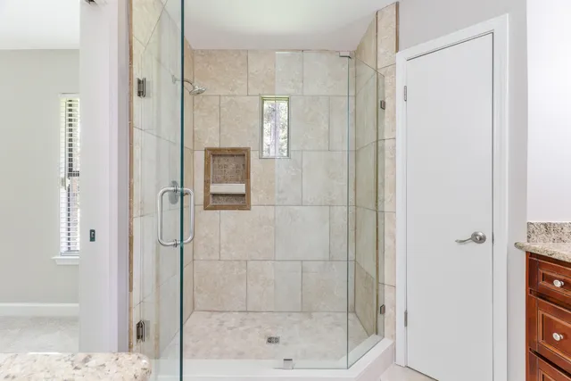 a bathroom with a shower and a glass door