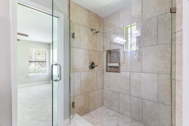 a bathroom with a shower and a glass door
