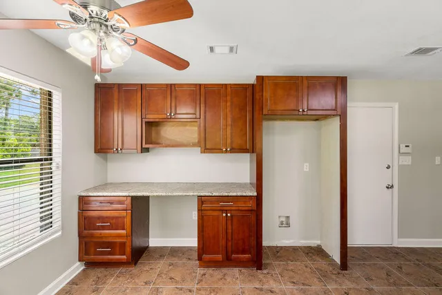 a kitchen with a refrigerator and a stove
