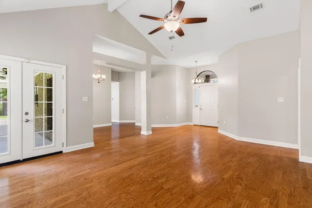 a view of empty room with wooden floor